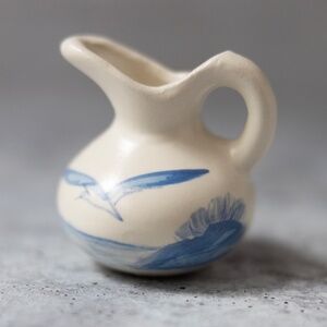 Painted seagull blue white pottery ceramic creamer signed Val 2.25 inches tall